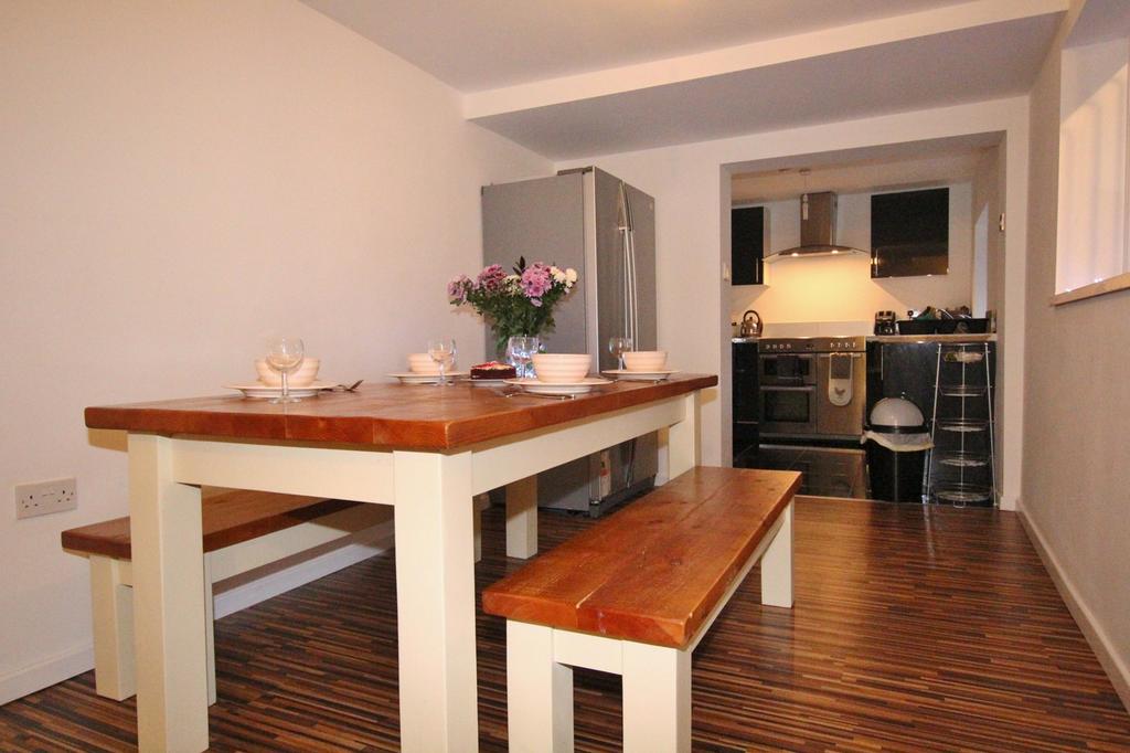 A cozy kitchenette featuring a dining table per...