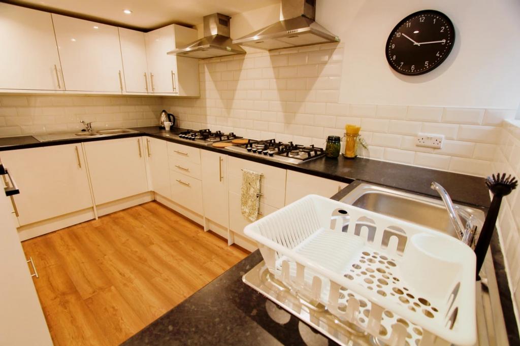 A modern and clean kitchenette with ample stora...