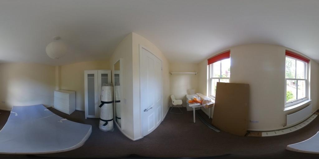 A spacious double bedroom with good natural lig...