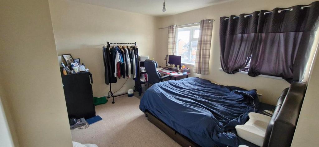 A spacious and well-lit double bedroom featurin...