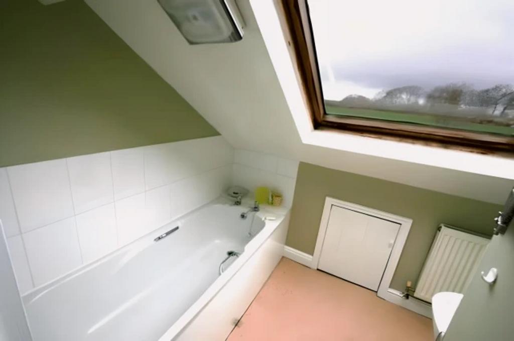 A cozy and well-maintained bathroom featuring a...