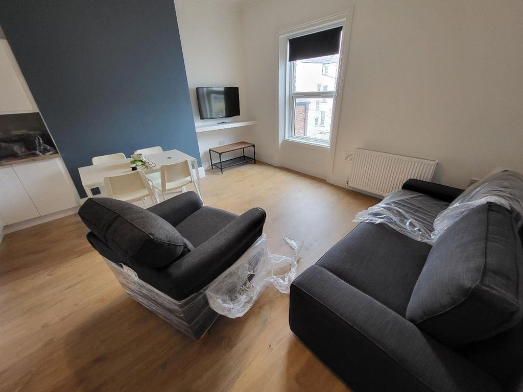 A bright and modern living room featuring styli...