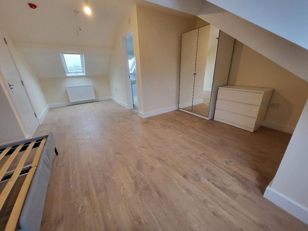 Spacious double bedroom featuring ample natural...
