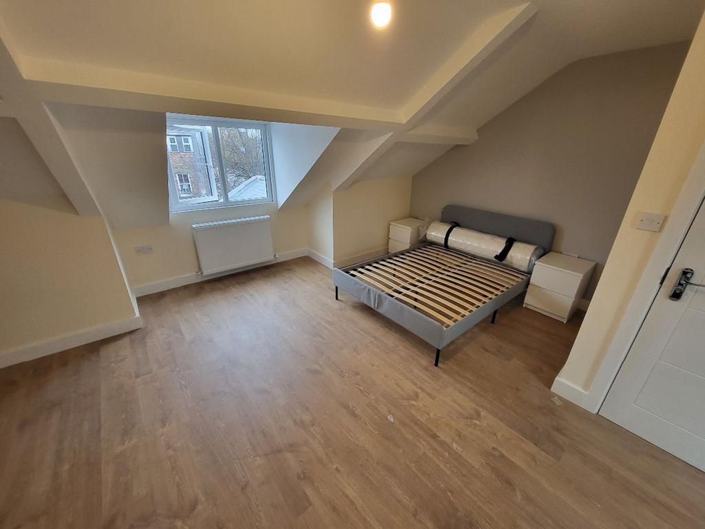 A bright and spacious double bedroom featuring ...