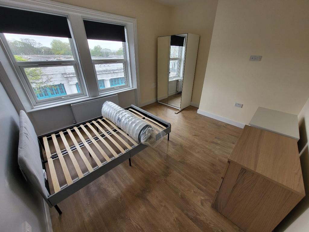 This inviting double bedroom features large win...