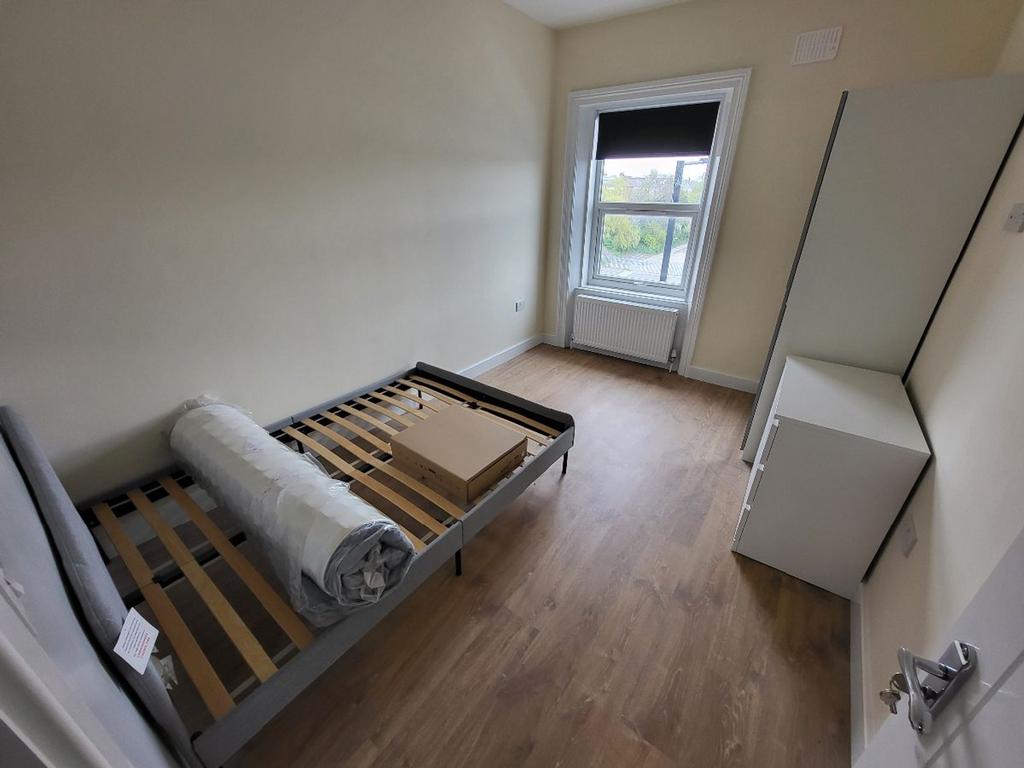 A bright and inviting double bedroom featuring ...