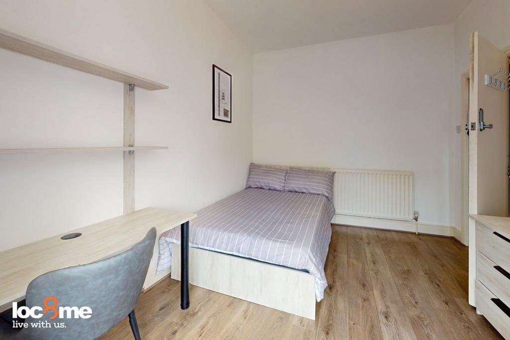 A bright and tidy double bedroom with a comfort...