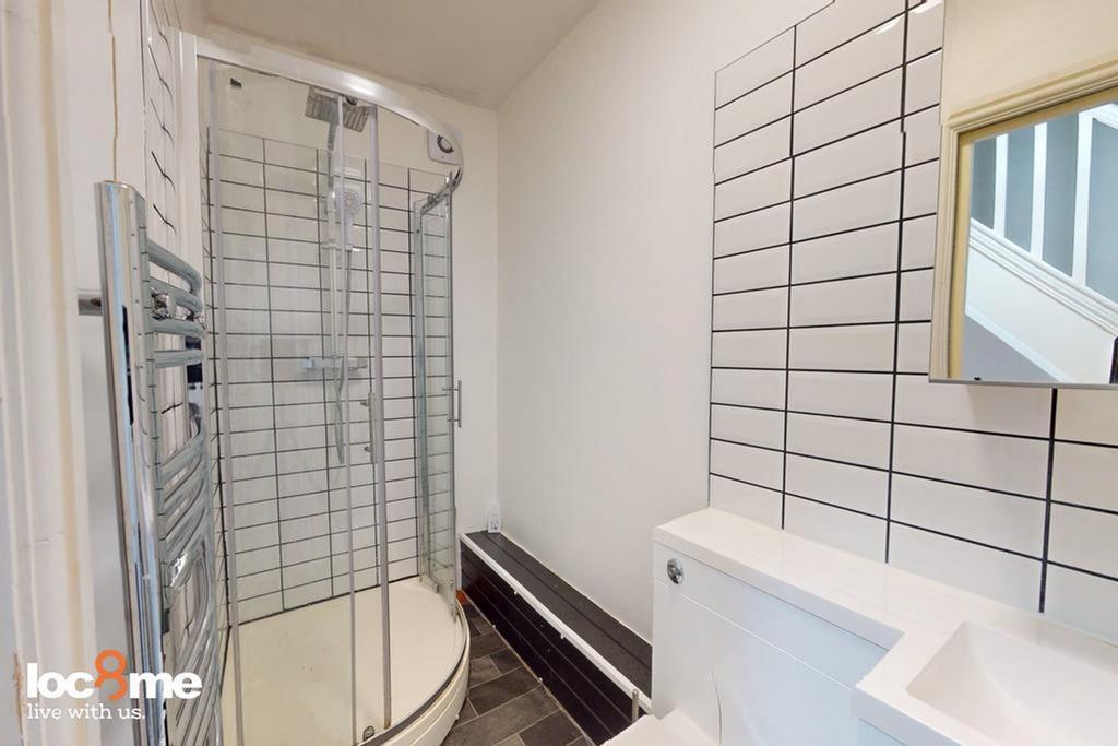 A modern and tidy bathroom featuring a spacious...