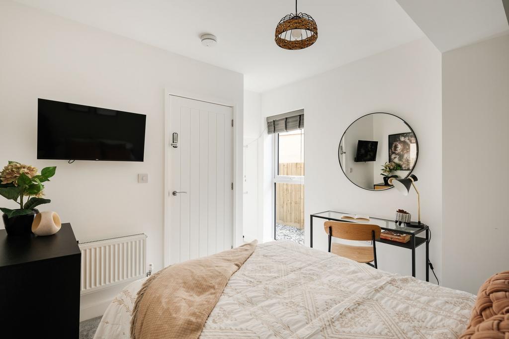 A bright and inviting double bedroom featuring ...