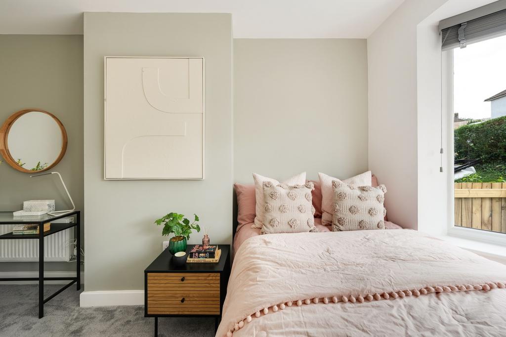 A stylish and well-lit double bedroom featuring...