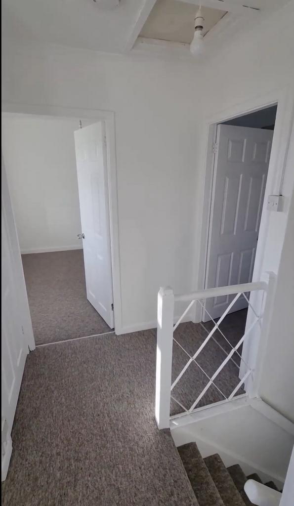 A clean and spacious hallway with ample natural...
