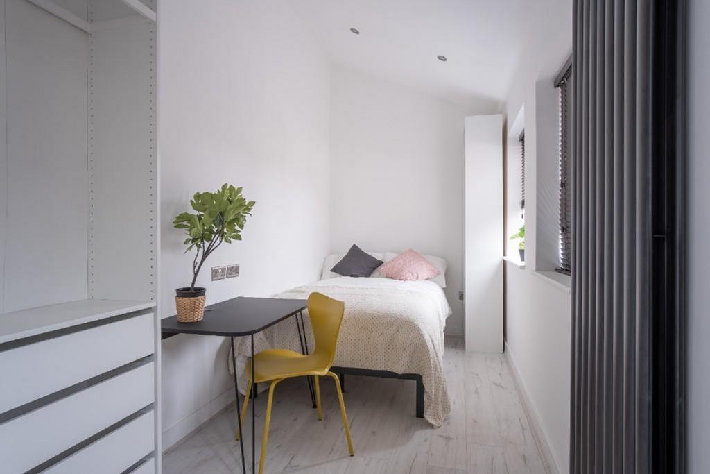 This inviting double bedroom features a cozy la...