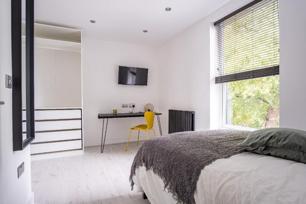 A stylish double bedroom featuring a comfortabl...