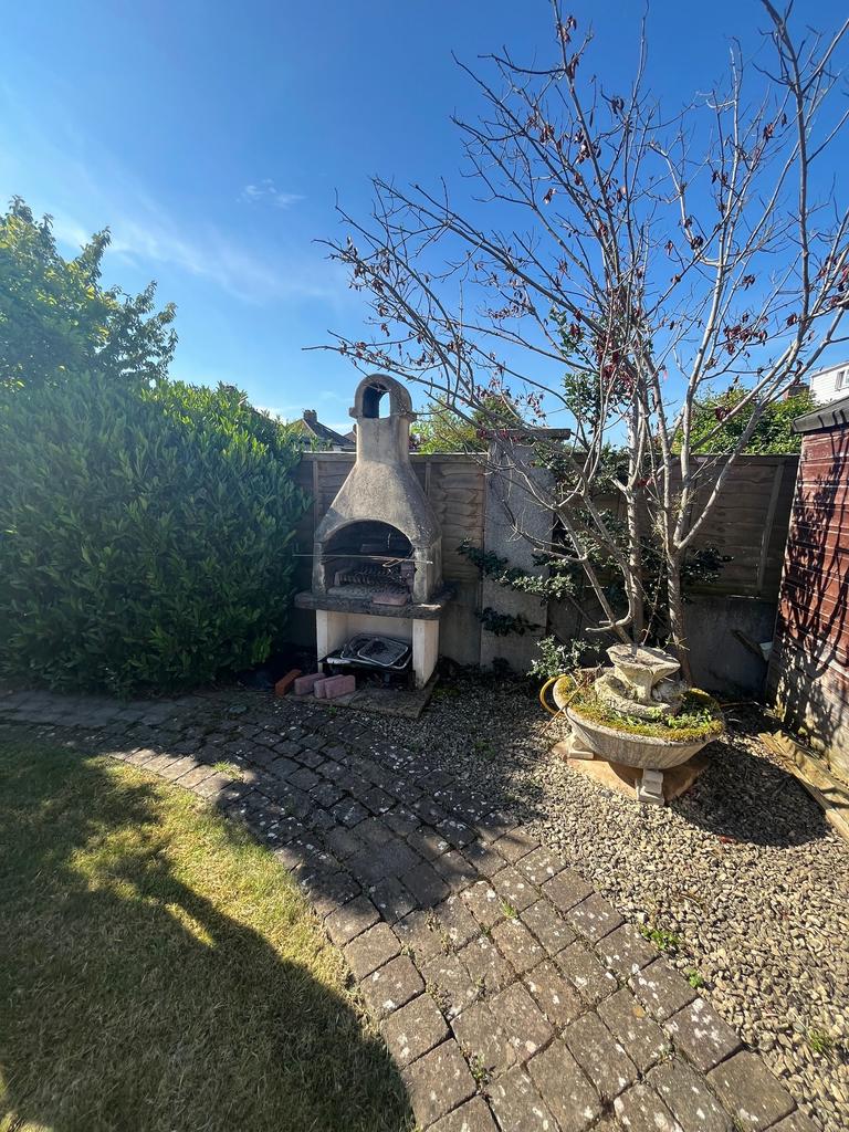 This charming garden features a well-maintained...