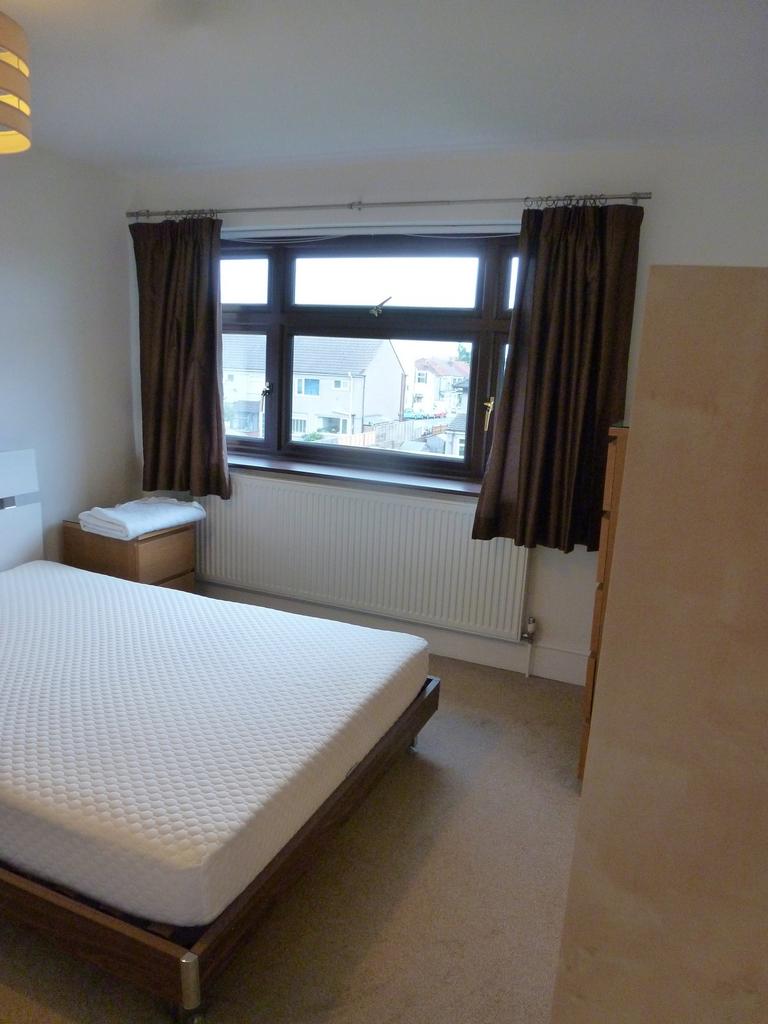 This inviting double bedroom features ample nat...