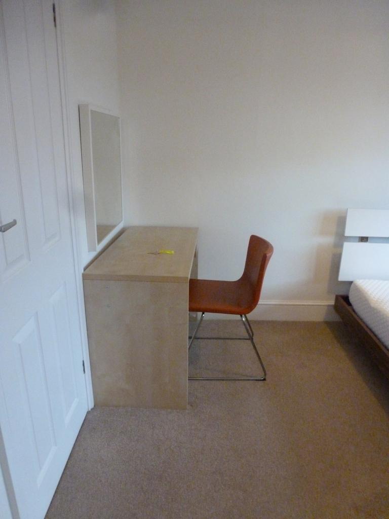This inviting double bedroom features a comfort...