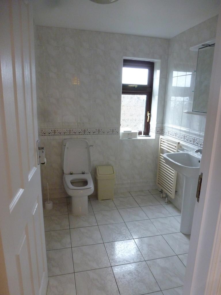 A well-maintained bathroom featuring modern fix...