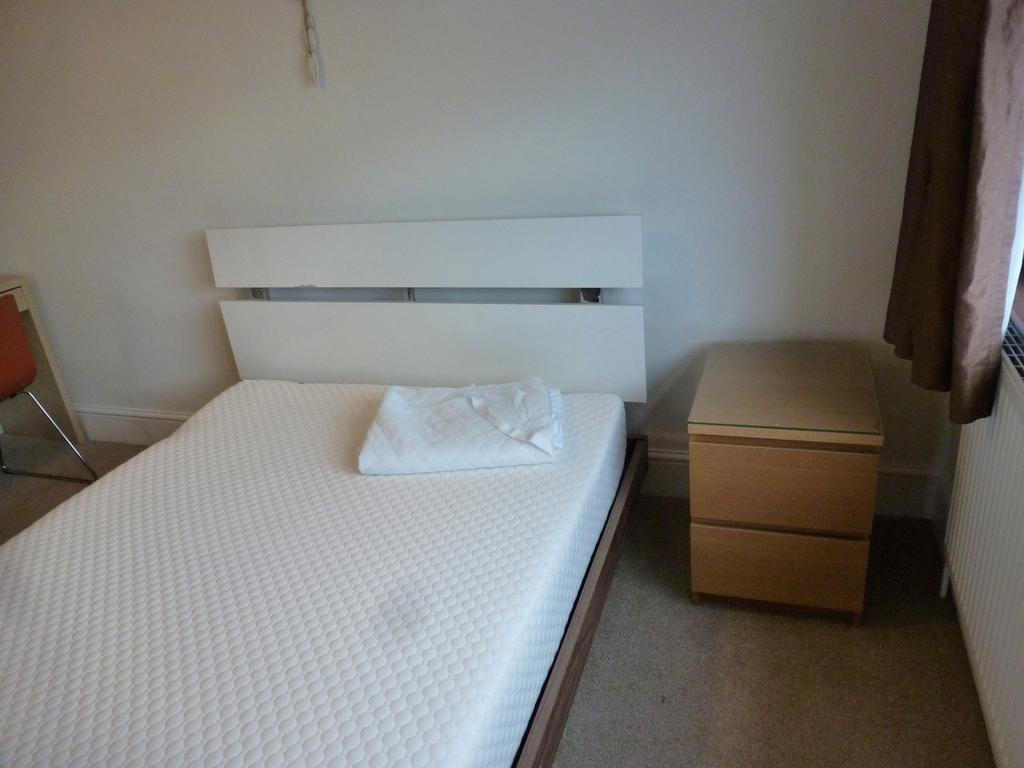 A cozy double bedroom featuring a modern bed fr...