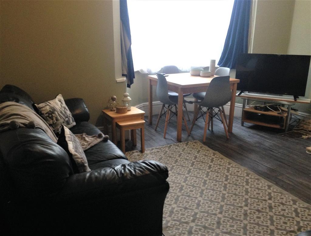 A cozy living room featuring a comfortable leat...
