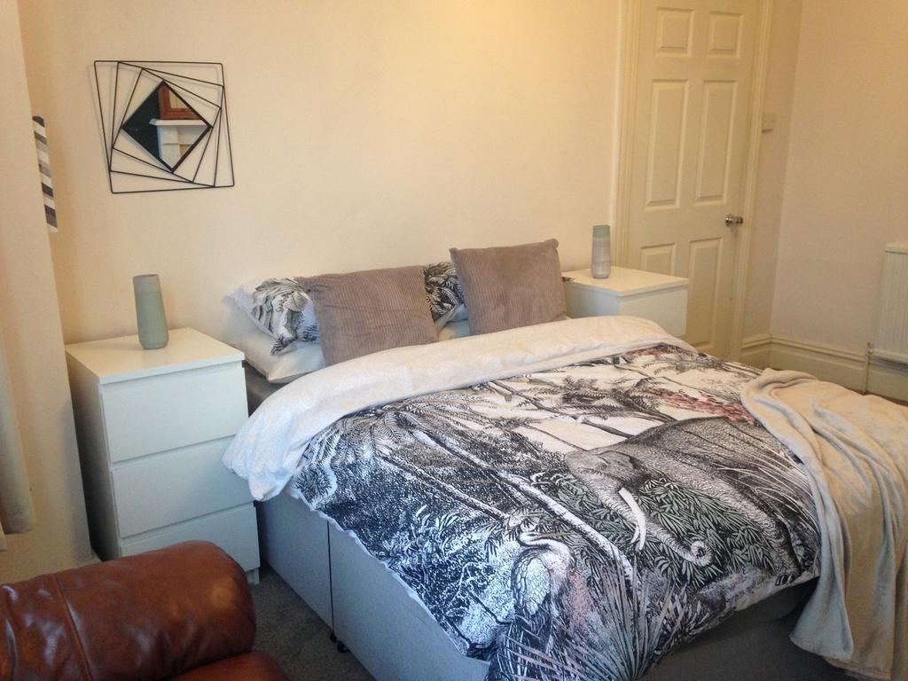 Cozy double bedroom featuring a stylish bed wit...