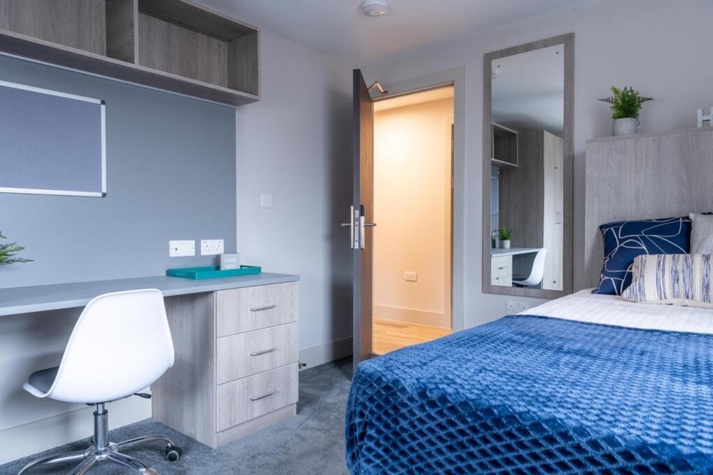 This inviting double bedroom features a cozy be...
