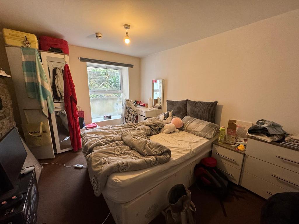 This inviting double bedroom features a comfort...