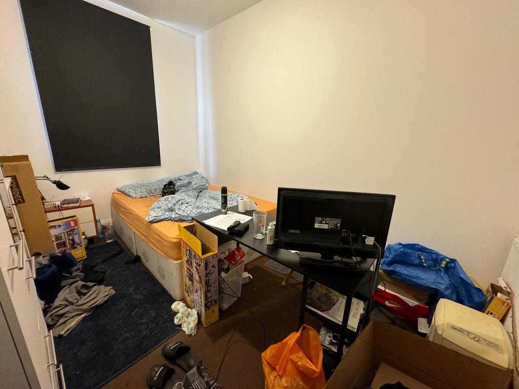 Cozy double bedroom featuring a comfortable bed...