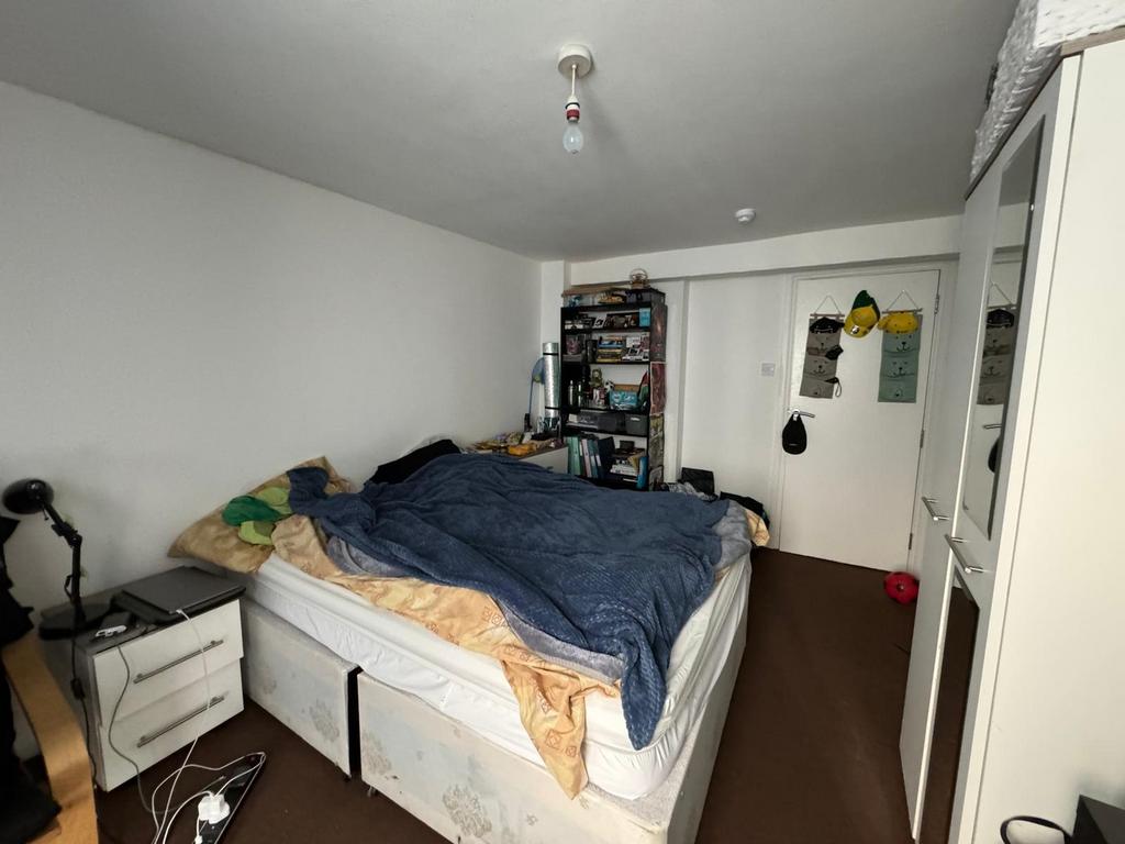 Cozy double bedroom featuring a comfortable bed...