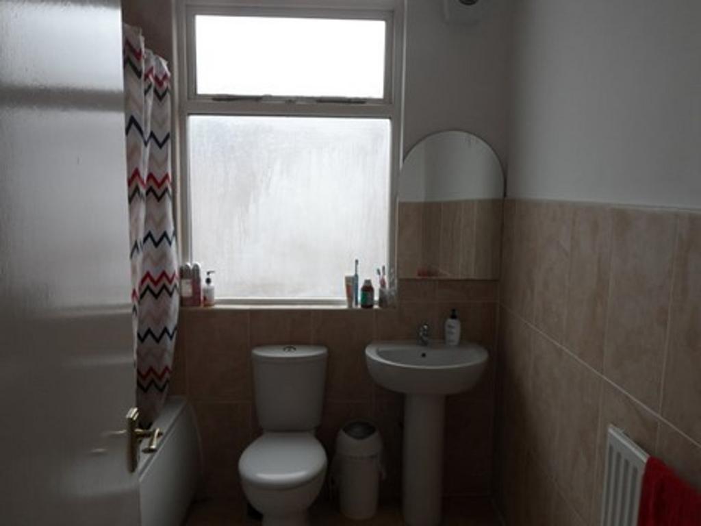 Bright and functional bathroom featuring a clea...