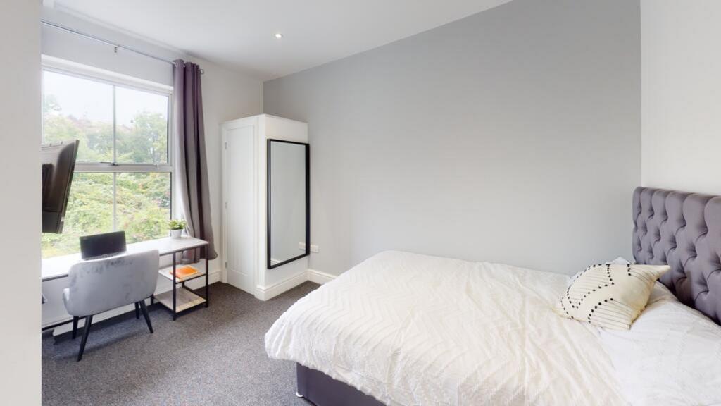 A stylish double bedroom featuring a comfortabl...