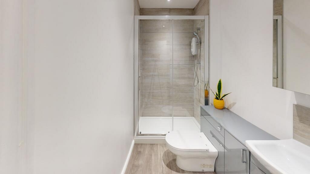 A modern bathroom featuring a stylish shower en...