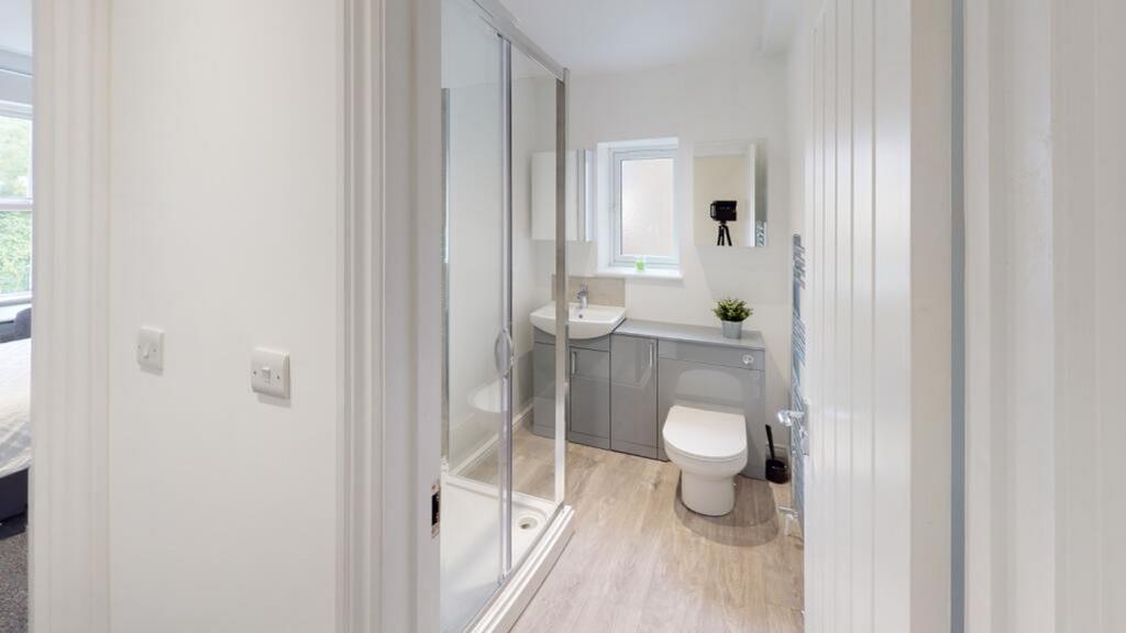 A modern bathroom featuring a sleek shower, sty...