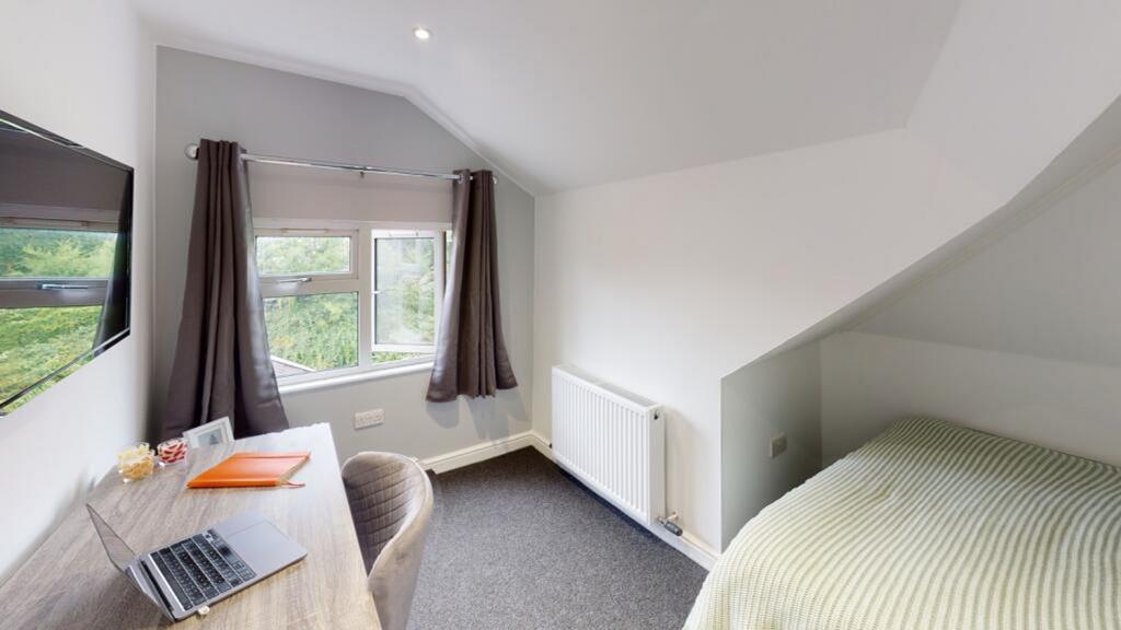 A cozy double bedroom featuring ample natural l...