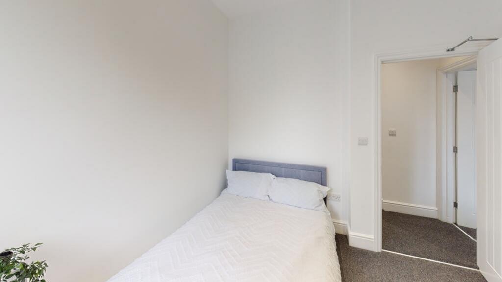 Cozy double bedroom featuring a comfortable bed...