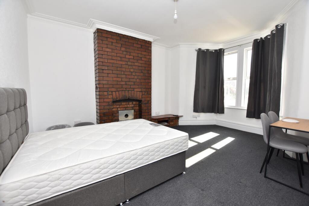 Bright and spacious double bedroom featuring a ...