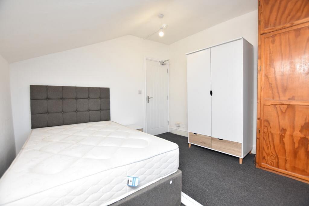 This spacious double bedroom features a contemp...