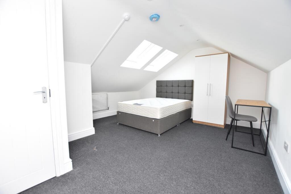 Spacious double bedroom featuring a comfortable...