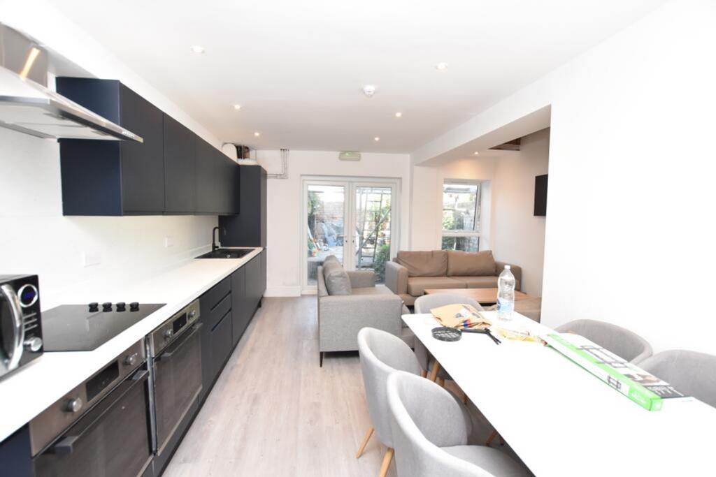 This modern kitchen boasts sleek cabinetry and ...
