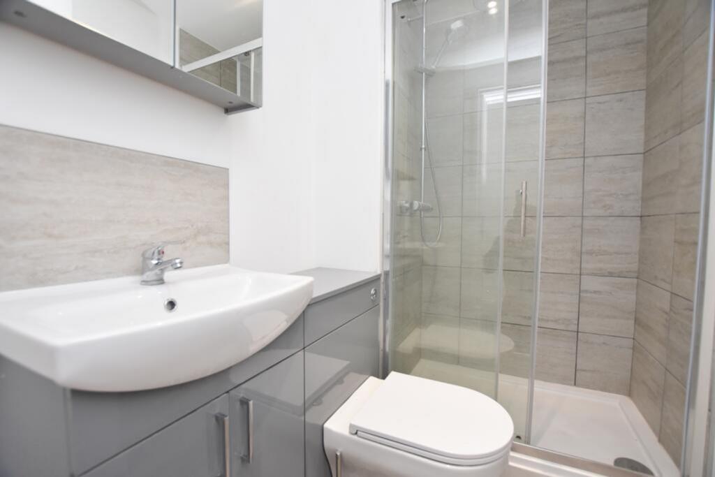 A modern bathroom featuring a sleek shower, sty...