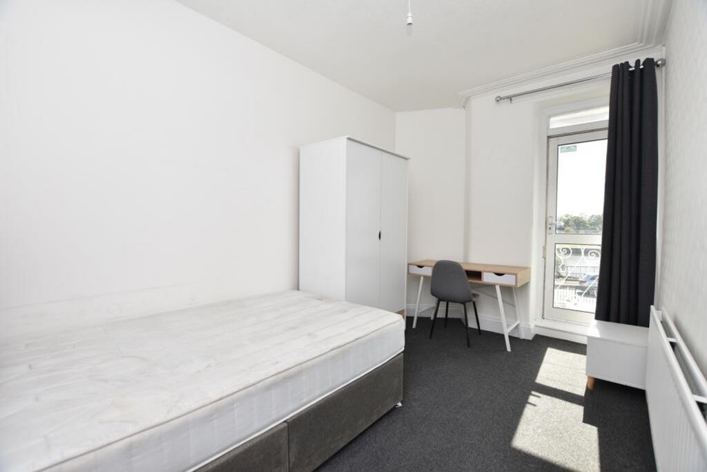 A bright and inviting double bedroom featuring ...