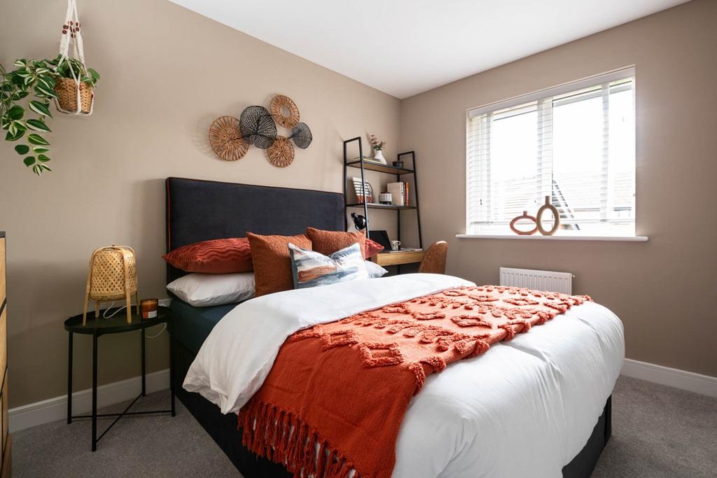 An inviting second bedroom with a double bed,...