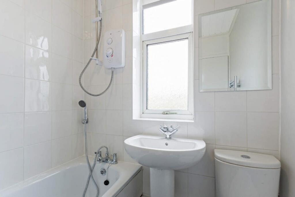 Modern bathroom featuring a clean design, natur...