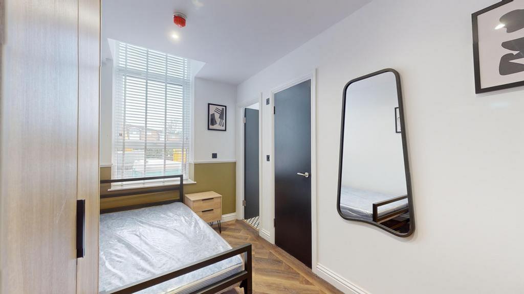 A bright and stylish double bedroom featuring m...
