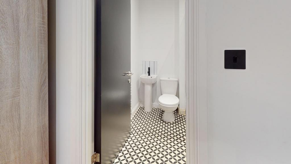 A stylish and clean single toilet with modern t...