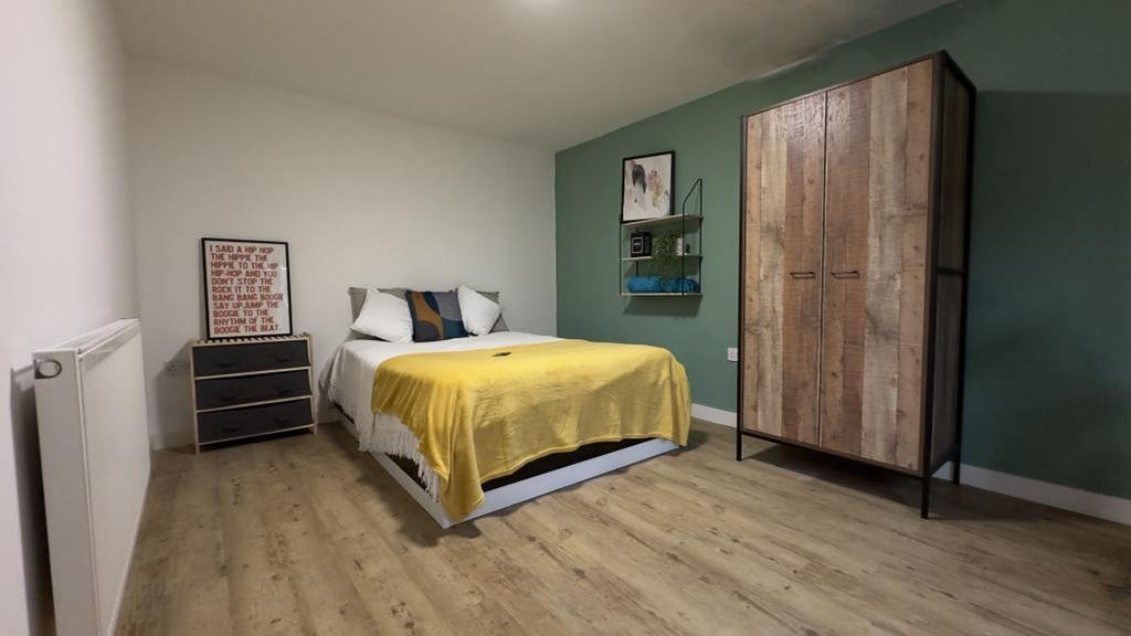 A spacious and inviting double bedroom featurin...