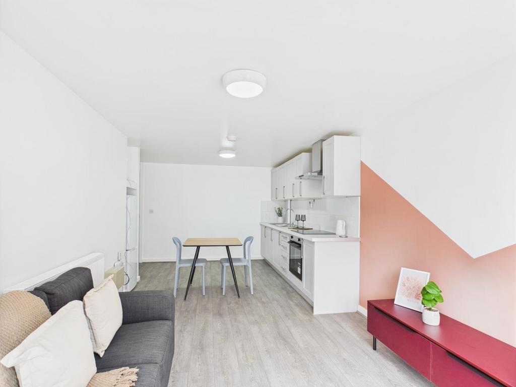 Bright, modern open-plan kitchen and living are...
