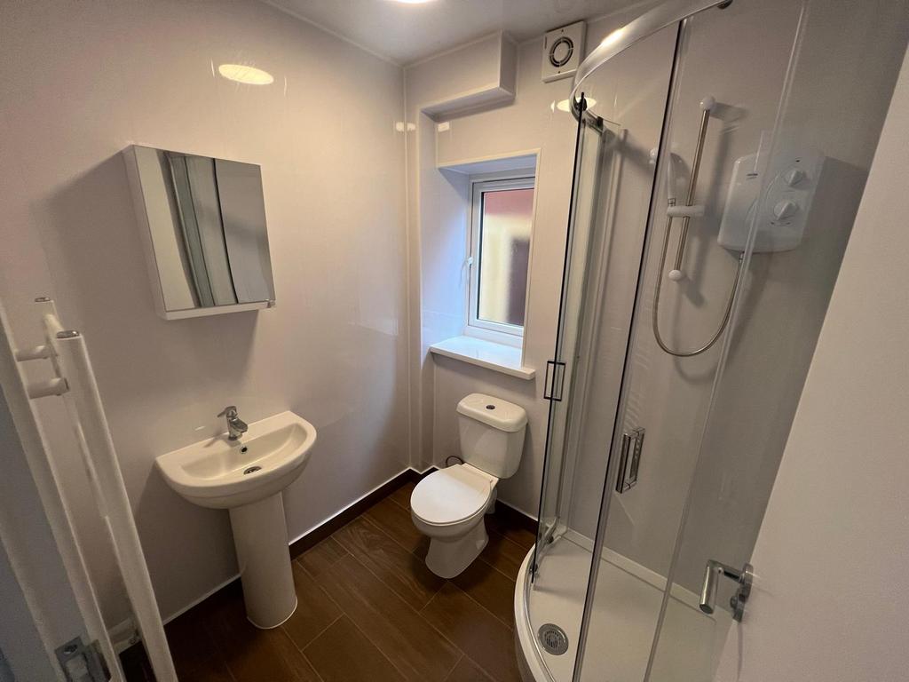 A modern bathroom featuring a sleek shower, con...