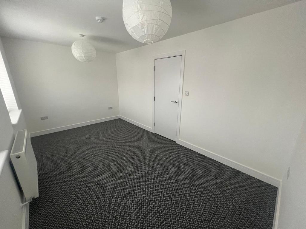 Spacious double bedroom featuring modern light ...