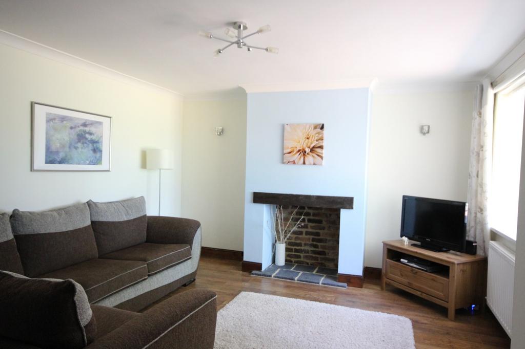Bright and inviting living room featuring a com...