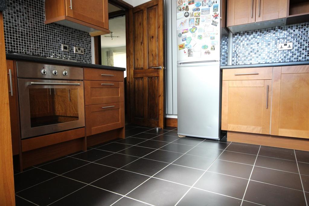 Spacious kitchen featuring modern cabinetry, a ...